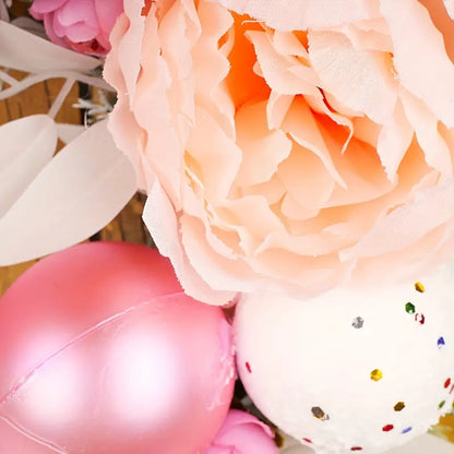 Blushing Elegance: A Pink Christmas Wreath Adorned with Baubles