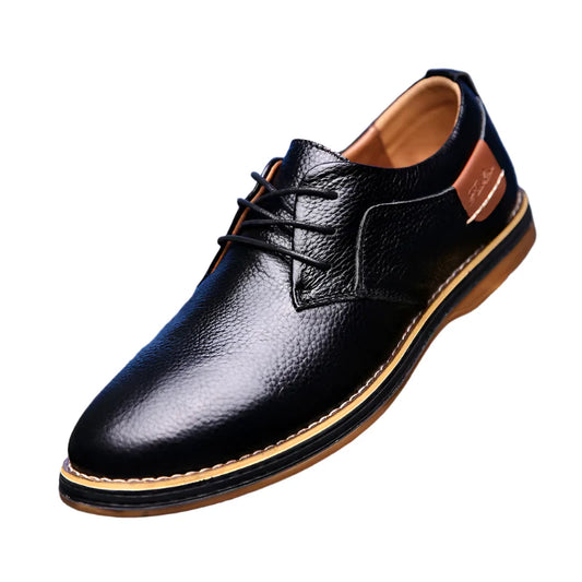 Black leather shoe on a reflective surface with a blue checkered background