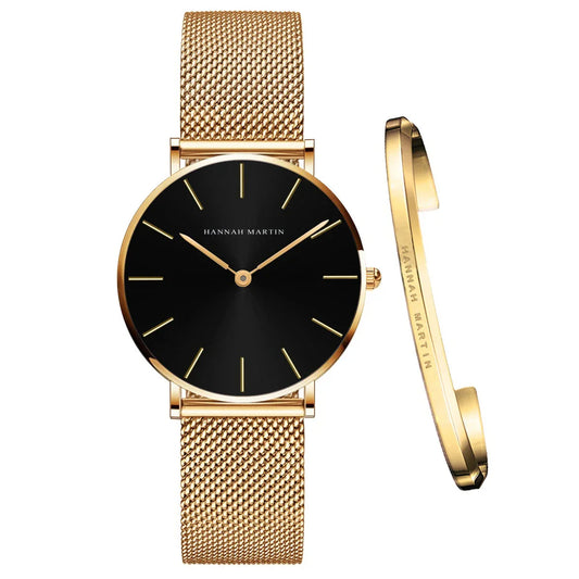Gold watch and bracelet with black face on a white background, featuring the Hannah Martin brand.