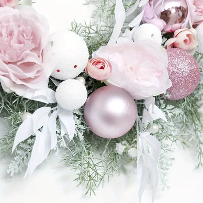 Blushing Elegance: A Pink Christmas Wreath Adorned with Baubles
